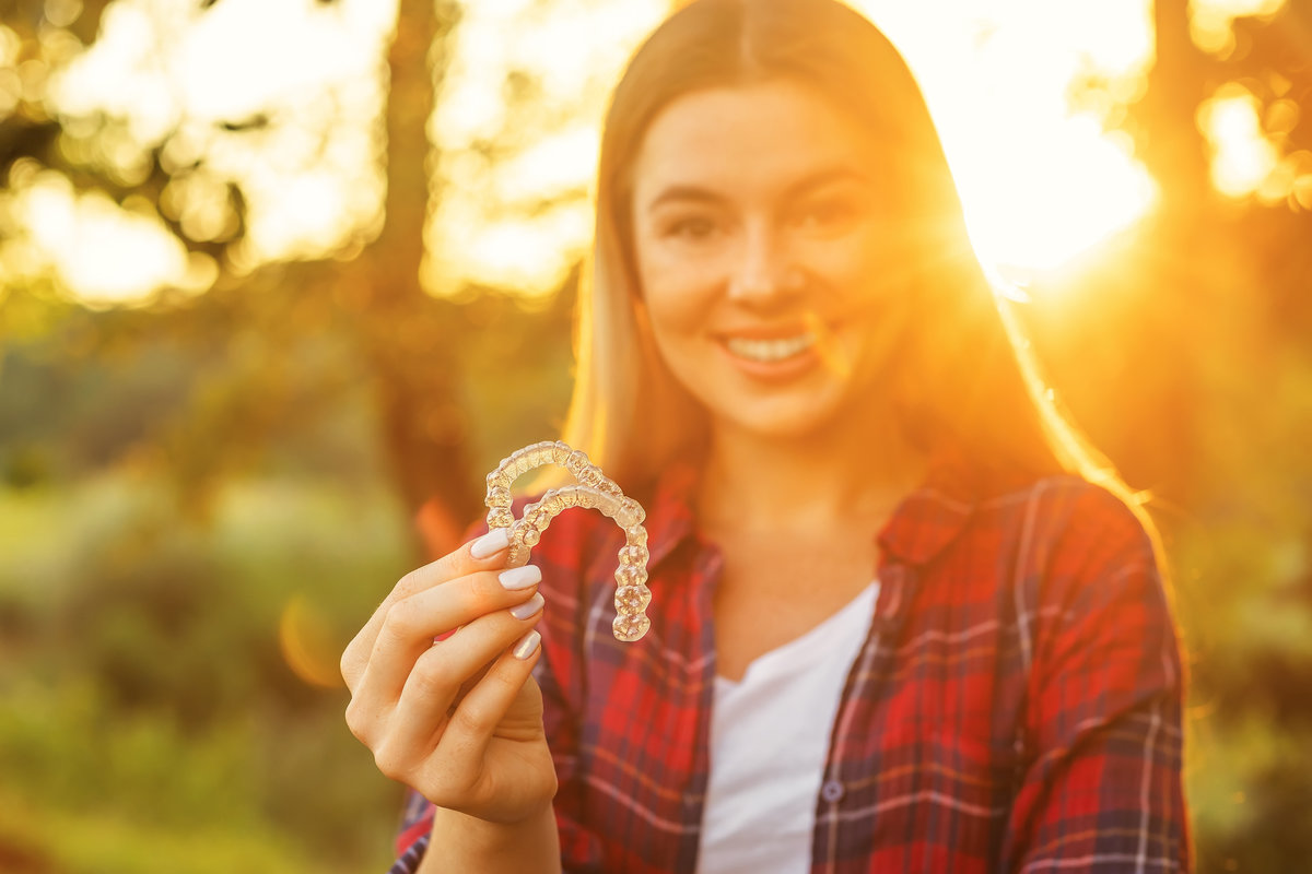 Woman with perfect smile after invisible dental aligners aligners treatment