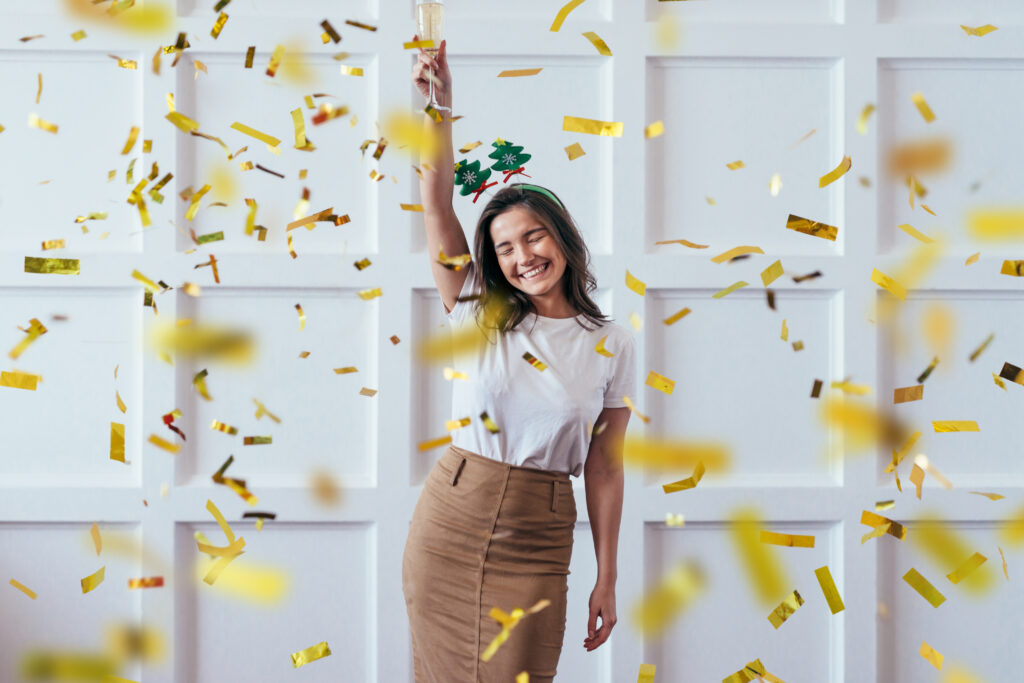 Portrait of young woman with glass celebrate Christmas or New Year.